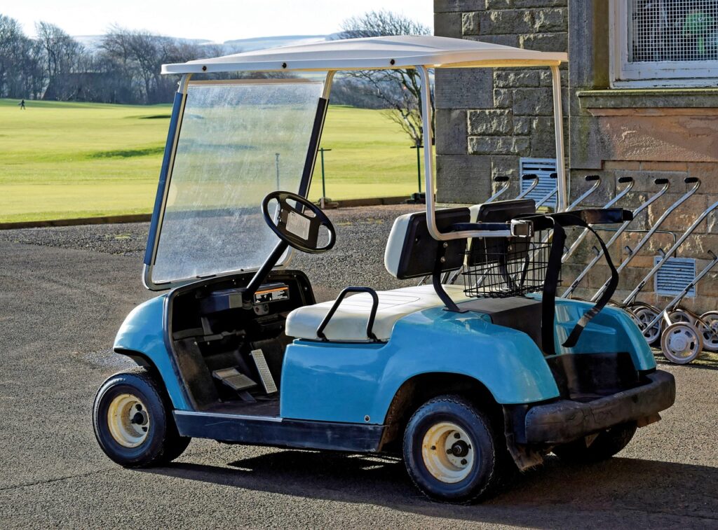 Blue golf cart parked on a smooth road, perfect for exploring Ambergris Caye, offering convenience for island exploration and access to remote areas
