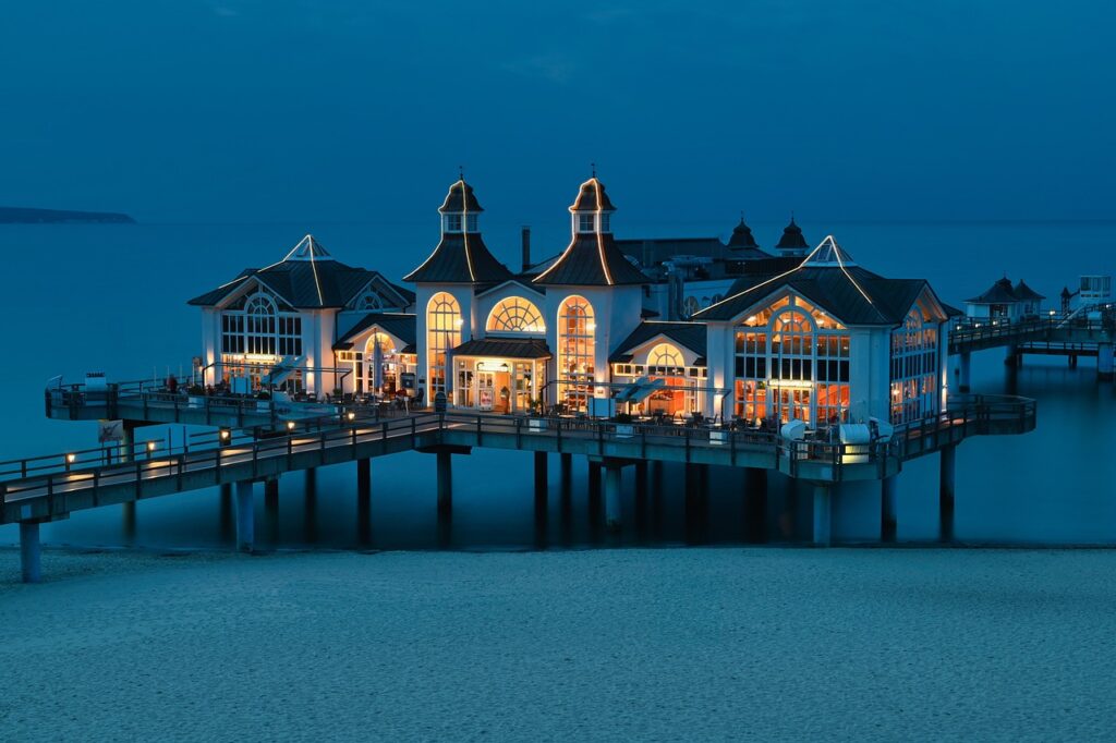 Beautiful resort pier at night with glowing lights and scenic views over the ocean, offering a relaxing atmosphere for evening relaxation on Ambergris Caye.