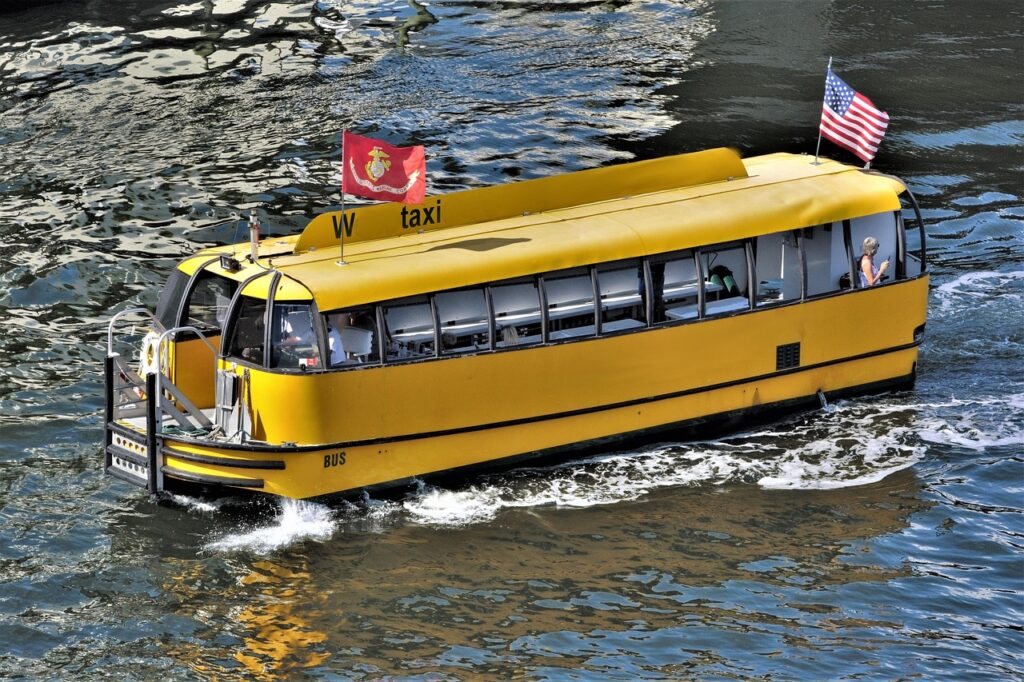 Yellow water taxi boat cruising on the water, offering a unique mode of transport with scenic views for travelers in Ambergris Caye, Belize